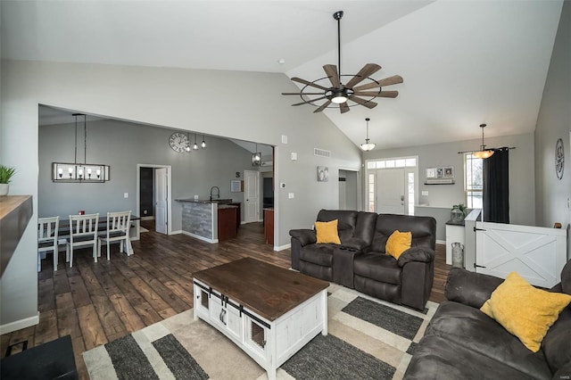 living room with visible vents, dark wood finished floors, baseboards, ceiling fan, and high vaulted ceiling