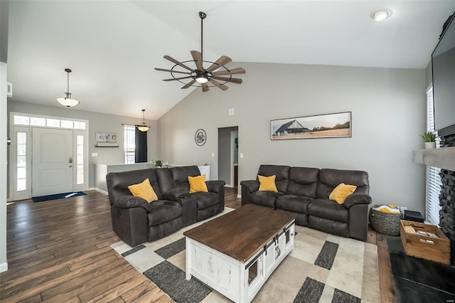 living room with a ceiling fan, a healthy amount of sunlight, a fireplace, and light wood finished floors