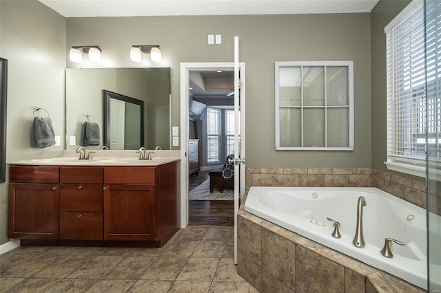 bathroom featuring double vanity, a jetted tub, and tile patterned floors