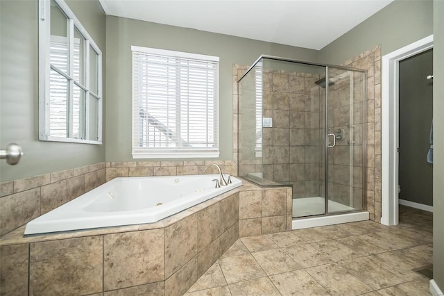 bathroom featuring a garden tub, tile patterned flooring, and a shower stall