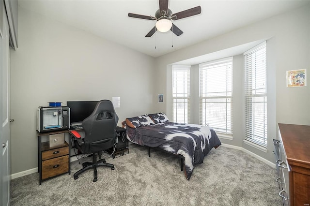 bedroom with baseboards, ceiling fan, and light colored carpet