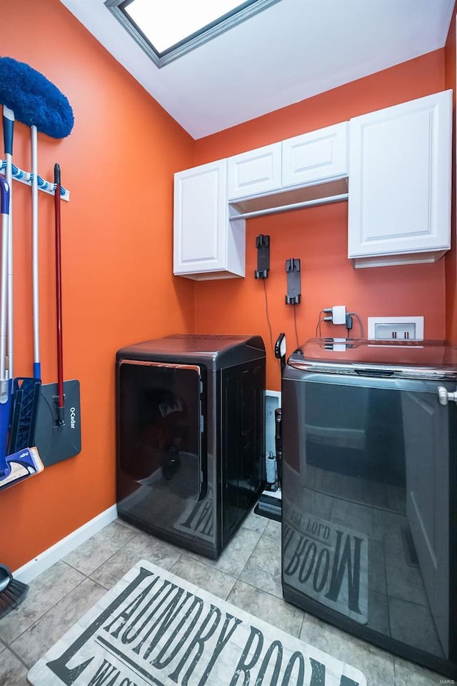 clothes washing area featuring cabinet space, light tile patterned floors, baseboards, and washer and dryer