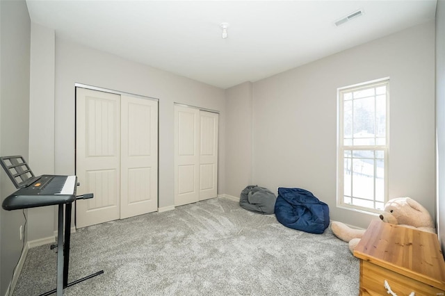 office space featuring carpet floors, baseboards, and visible vents