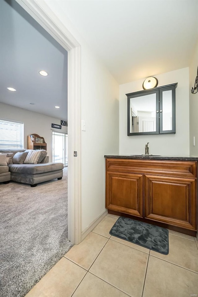 bathroom featuring baseboards, vanity, and tile patterned floors