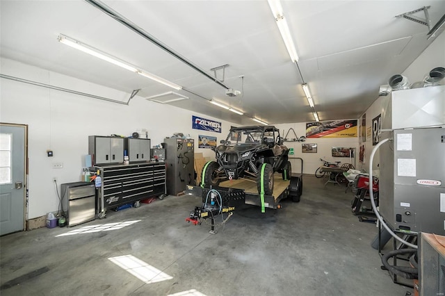 garage with a workshop area and a garage door opener