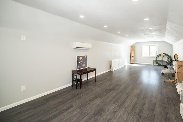 bonus room with recessed lighting, dark wood-type flooring, baseboards, vaulted ceiling, and a wall mounted air conditioner