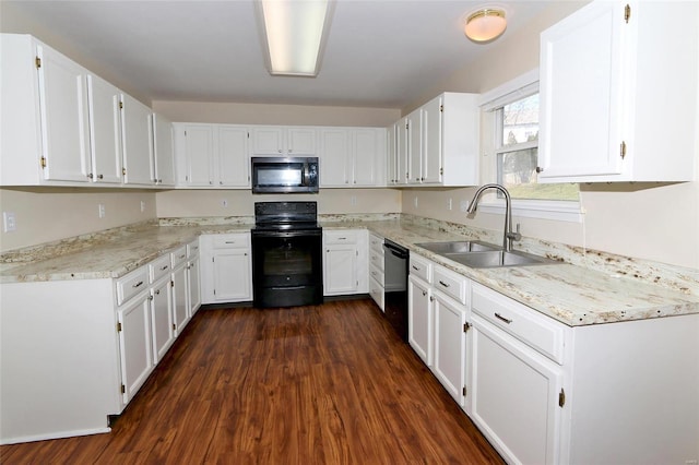 kitchen with white cabinetry, black appliances, and a sink