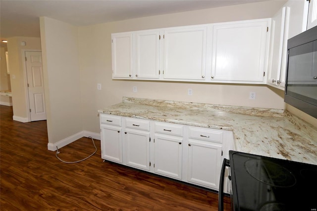 kitchen featuring light stone countertops, white cabinetry, and dark wood-style flooring