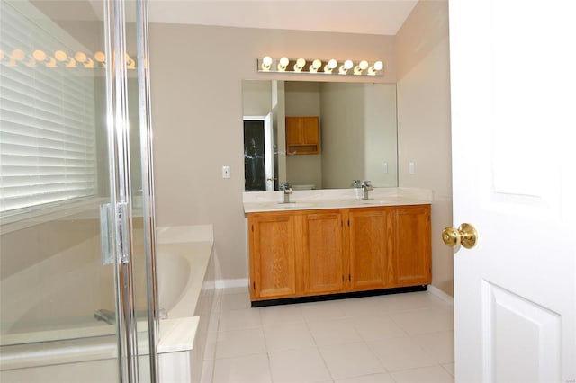 bathroom featuring double vanity, a stall shower, a bath, and a sink