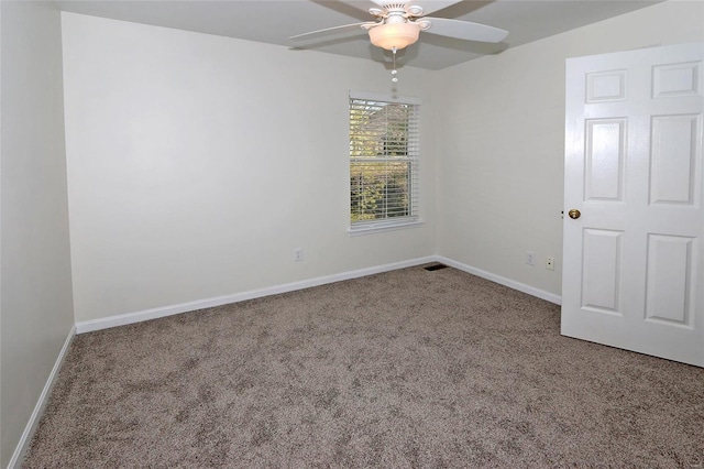 empty room featuring baseboards, carpet floors, visible vents, and ceiling fan