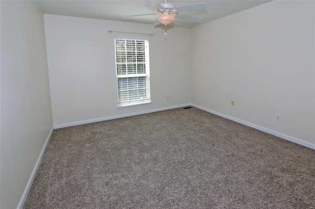 spare room featuring visible vents, baseboards, ceiling fan, and carpet flooring