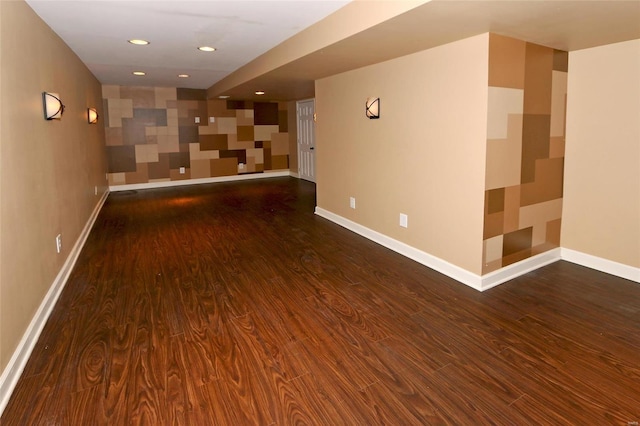 spare room featuring recessed lighting, wood finished floors, and baseboards