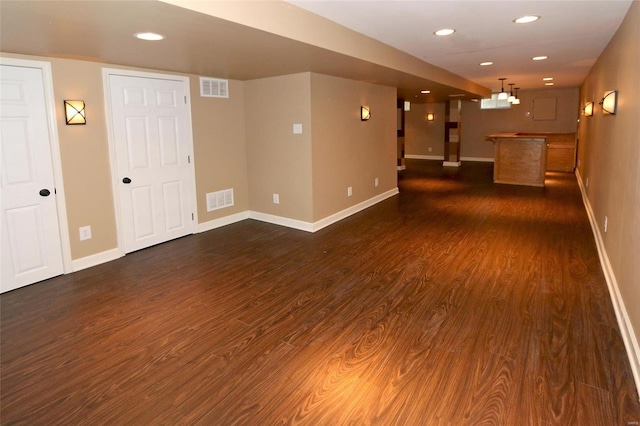 interior space featuring recessed lighting, visible vents, and dark wood-style floors