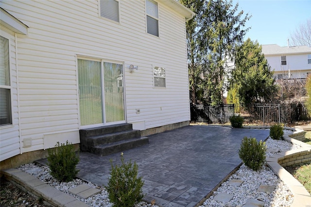 view of patio / terrace featuring entry steps and fence