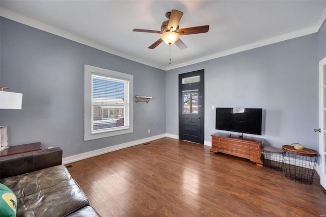 living area featuring a wealth of natural light, baseboards, and dark wood-type flooring