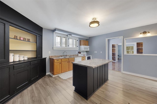 kitchen featuring white appliances, brown cabinetry, a kitchen island, light wood-type flooring, and open shelves