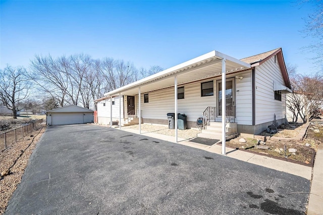 ranch-style house with a garage and an outbuilding