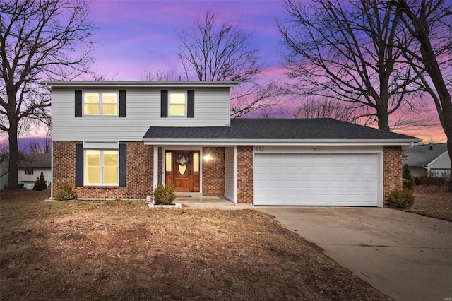 traditional home with an attached garage, driveway, and brick siding