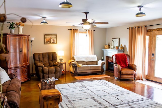 living room featuring ceiling fan and dark hardwood / wood-style floors