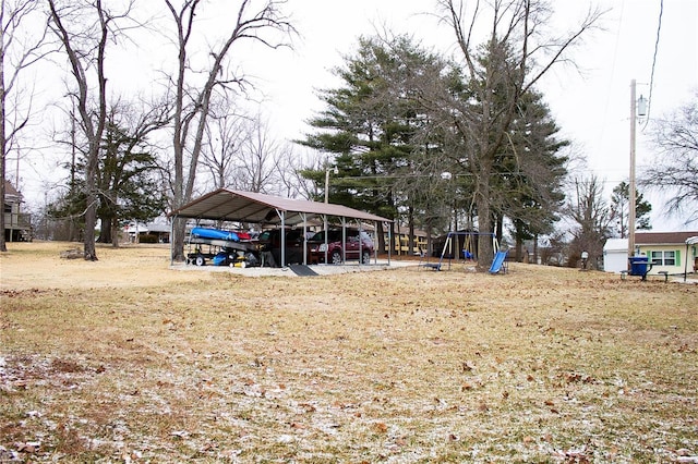 view of yard with a playground and a carport