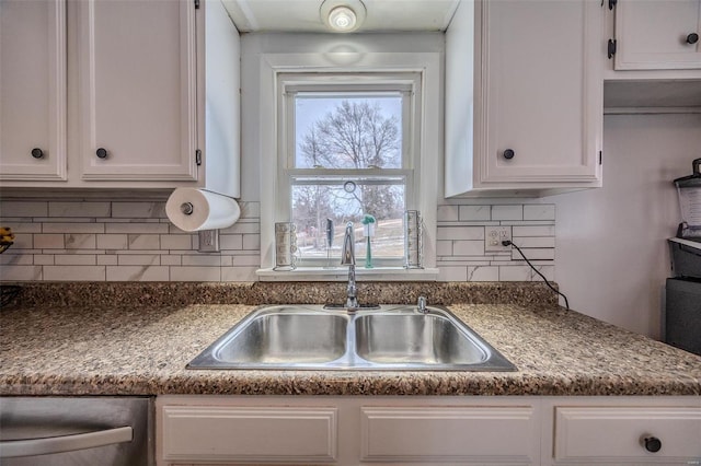 kitchen featuring white cabinetry, dishwasher, sink, and tasteful backsplash