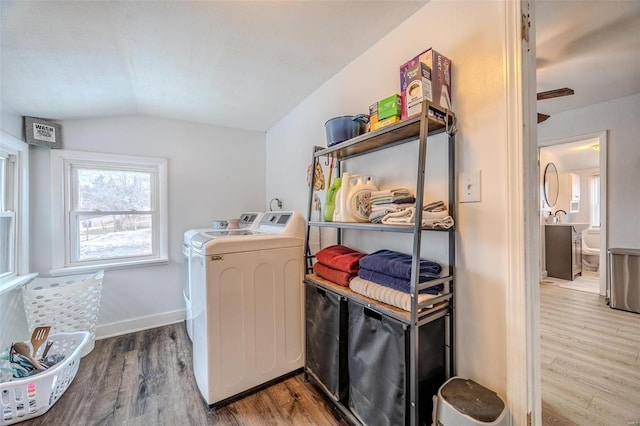 laundry room with wood-type flooring and washer and dryer