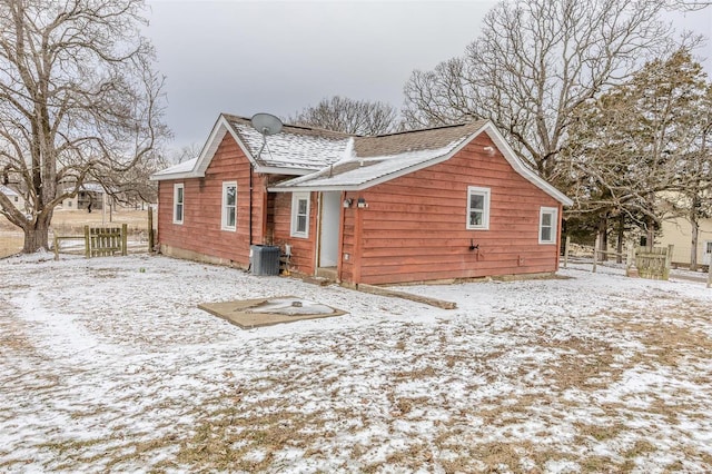 view of snowy exterior featuring central AC unit