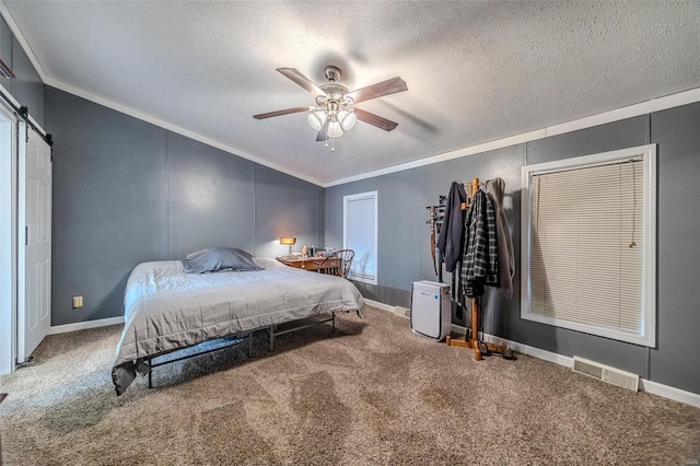 carpeted bedroom featuring lofted ceiling, a textured ceiling, ornamental molding, ceiling fan, and a barn door