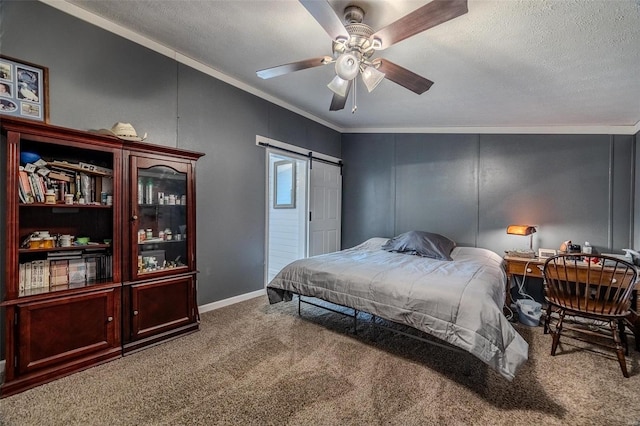 carpeted bedroom with crown molding, ceiling fan, a barn door, and a textured ceiling