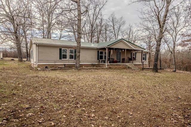 manufactured / mobile home with a porch and a front yard