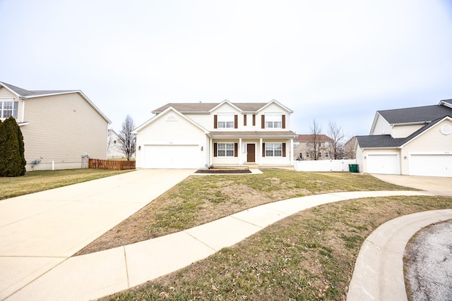 traditional-style house featuring a front yard, fence, a porch, concrete driveway, and a garage