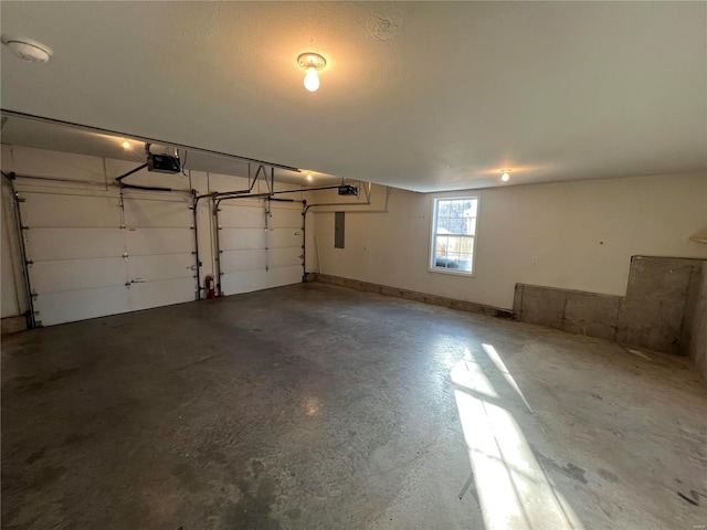 garage featuring a garage door opener and electric panel