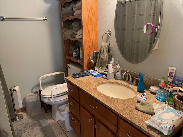 bathroom with tile patterned floors, toilet, and vanity