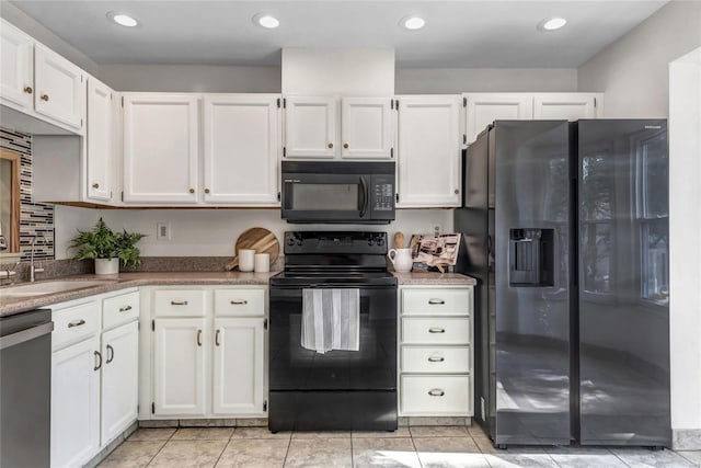 kitchen featuring black appliances, light tile patterned floors, white cabinetry, and recessed lighting