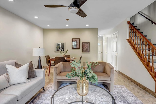 living area featuring ceiling fan, light tile patterned floors, recessed lighting, baseboards, and stairs