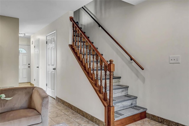 stairway with tile patterned flooring and baseboards