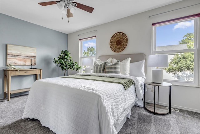 carpeted bedroom featuring baseboards and a ceiling fan