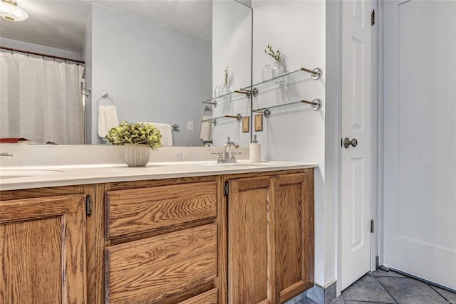 full bath featuring vanity and tile patterned floors