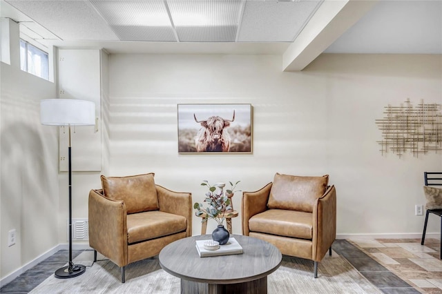 living area with visible vents and baseboards