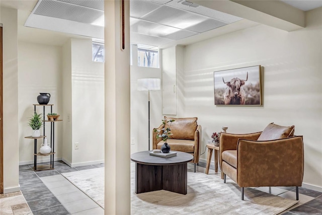 living area with visible vents and baseboards