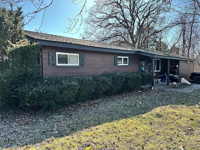 ranch-style house with a patio and a front lawn