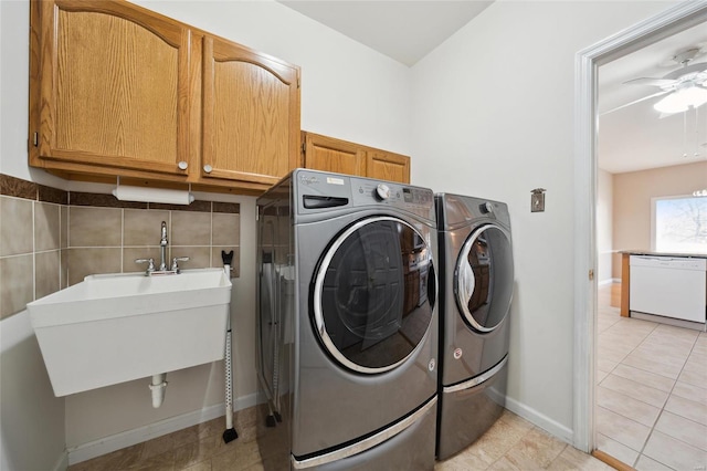 clothes washing area with light tile patterned floors, cabinet space, independent washer and dryer, a ceiling fan, and a sink