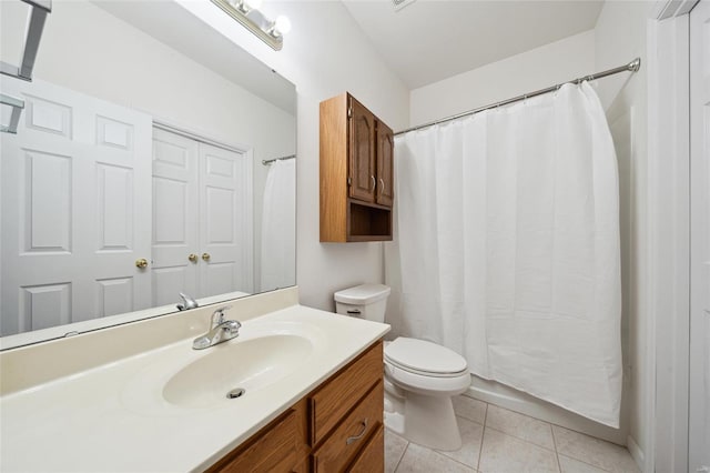 bathroom with tile patterned flooring, curtained shower, toilet, and vanity