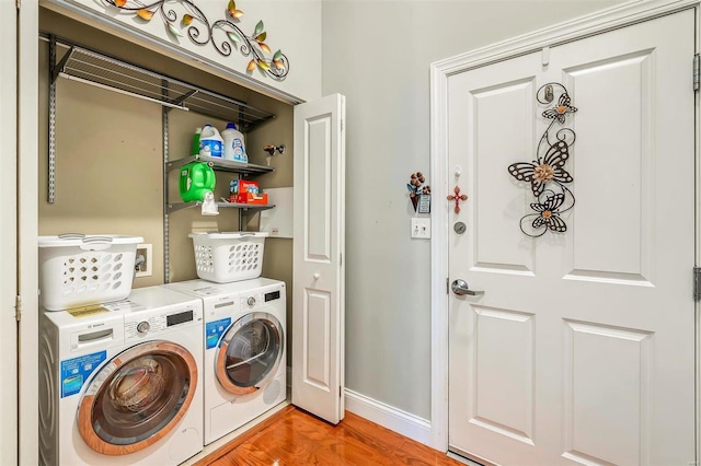 clothes washing area featuring independent washer and dryer and light wood-type flooring