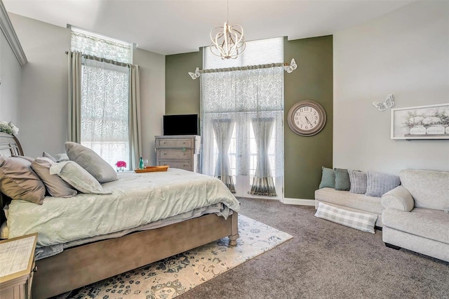 carpeted bedroom featuring a notable chandelier