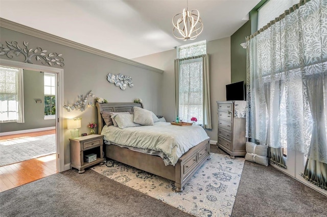 bedroom with light colored carpet and a notable chandelier