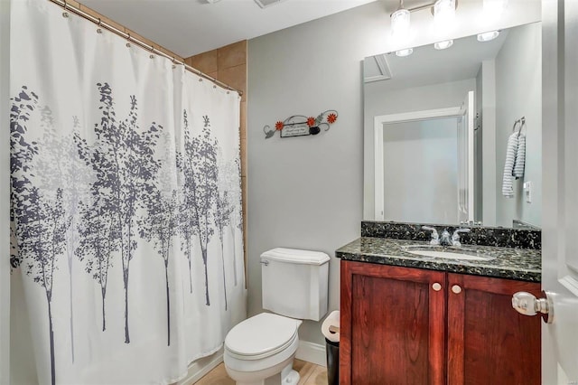 bathroom featuring vanity, curtained shower, and toilet