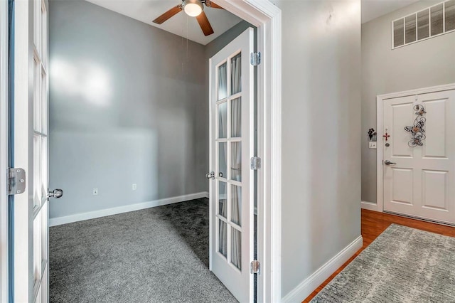 carpeted entryway with french doors and ceiling fan