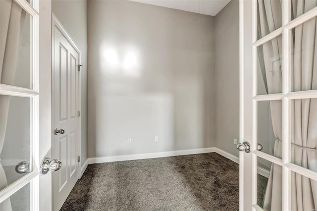 carpeted spare room featuring french doors