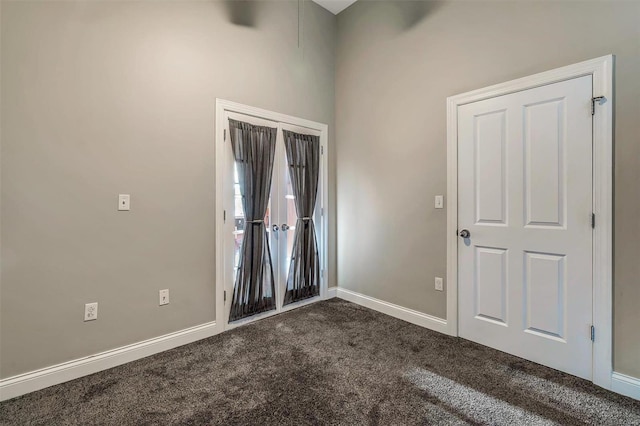 unfurnished room with dark carpet